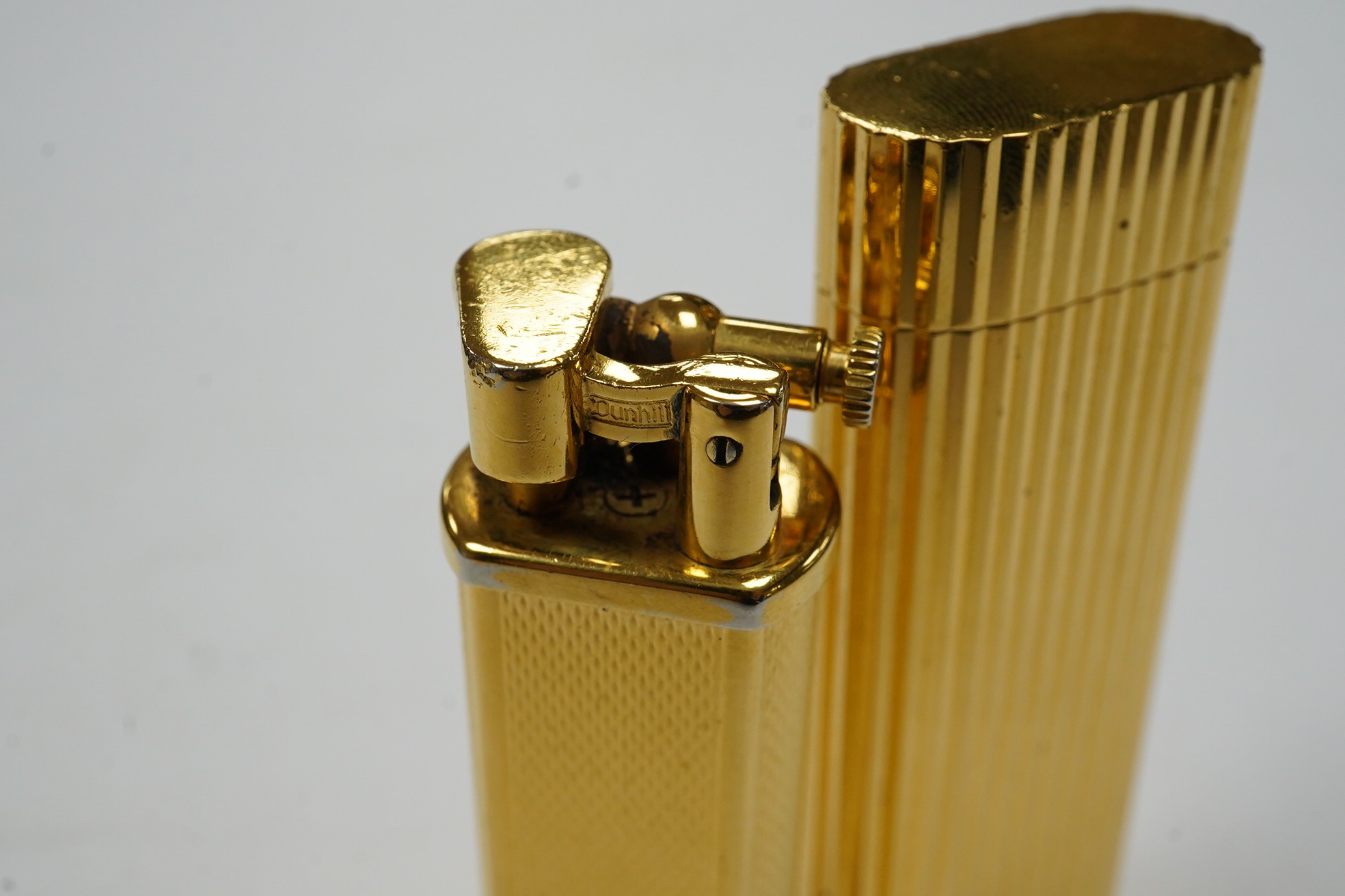 A Dunhill Sylphida lighter and Cartier lighter, numbered 88821. Condition - fair